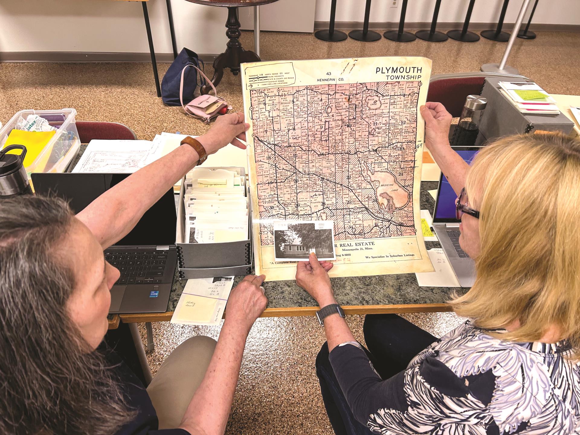 Visitors at the Plymouth History Center viewing an old map