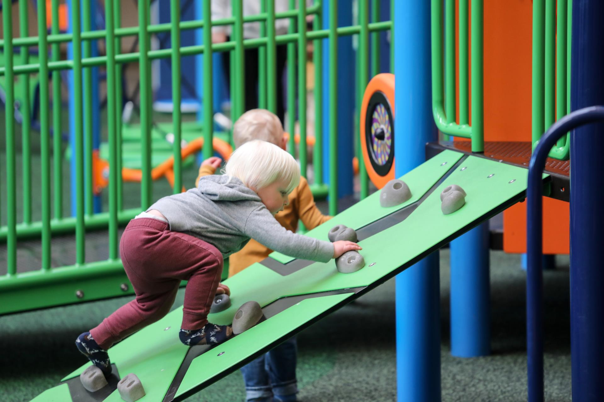 Two children play at the KUBE